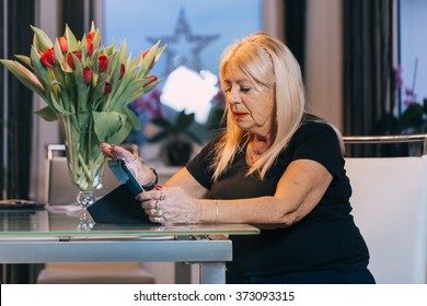 Senior Woman Using Tablet Pc Computer At Home