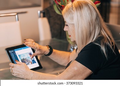 Senior Woman Using Tablet Pc Computer At Home