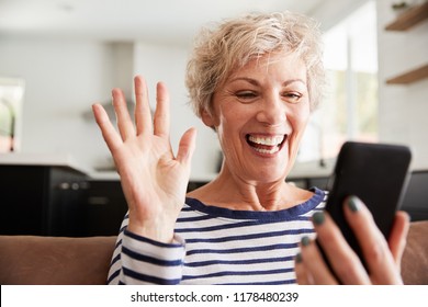 Senior woman video calling on smartphone at home, close up - Powered by Shutterstock