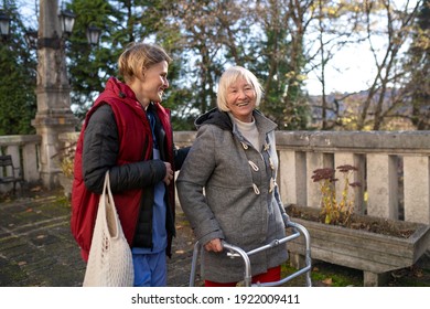 Senior woman with walking frame and caregiver outdoors in town, shopping and coronavirus concept. - Powered by Shutterstock