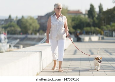 Senior Woman Walking Her Dog