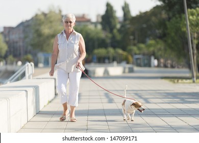 Senior Woman Walking Her Dog