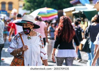 Senior Woman Walking In The Middle Of A Street Market