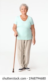 Senior Woman With Walking Stick On White Background