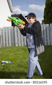 Senior Woman In A Water Gun Fight