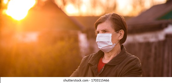 Senior woman wearing facial mask during outbreak of corona virus and flu. Protection against diseases and illnesses. Surgical masks for the prevention of coronavirus. A sick elderly patient coughs. - Powered by Shutterstock