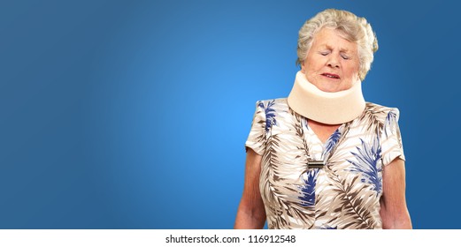 A Senior Woman Wearing A Neck brace On Blue Background - Powered by Shutterstock