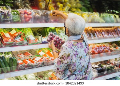 Senior Woman Wearing Protective Mask Doing Grocery Shopping In Supermarket