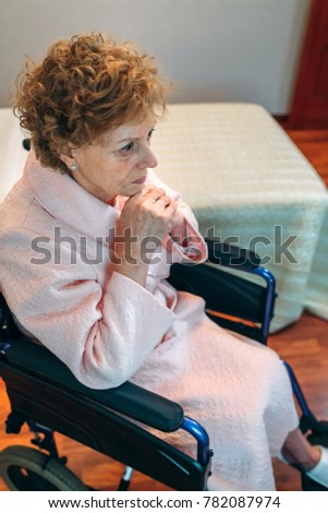 Image, Stock Photo Senior woman in a wheelchair alone in a room