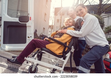 Senior woman in wheelchair being picked up by transport service - Shutterstock ID 2223058039