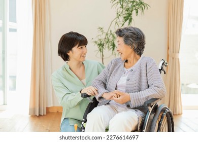Senior woman in wheelchair indoors with grandson