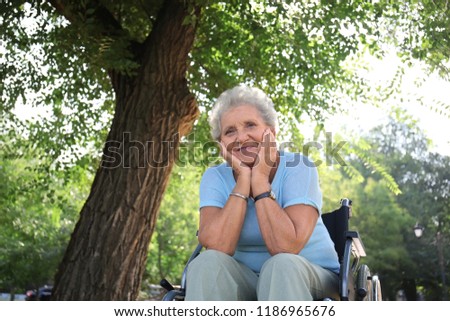 Similar – Smiling senior woman in wheelchair