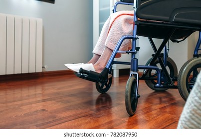 Senior Woman Who Uses A Wheelchair Alone In A Room