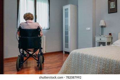 Senior Woman Who Uses A Wheelchair Alone In A Room