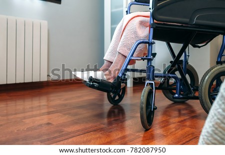 Senior woman in a wheelchair alone