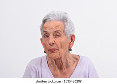 Senior Woman Wink The Eye On White Background