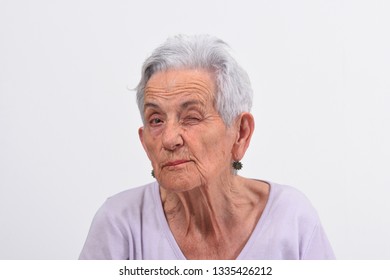 Senior Woman Wink The Eye On White Background