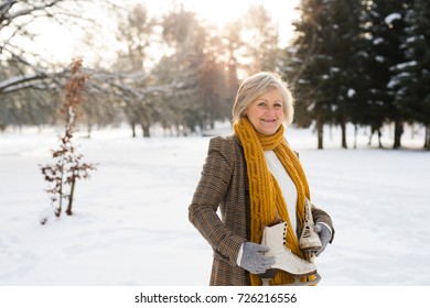 Senior Woman In Winter Nature Going Ice Skating.