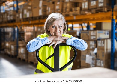 Senior Woman Worker Or Supervisor In A Warehouse.