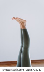 Senior Woman Working Out, Warming Up, Lying In Yoga Posture. One Leg Lift Exercise, Reclined Variation Of Extended Hand To Big Toe Pose At Home