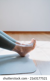 Senior Woman Working Out, Warming Up, Lying In Yoga Posture. One Leg Lift Exercise, Reclined Variation Of Extended Hand To Big Toe Pose At Home