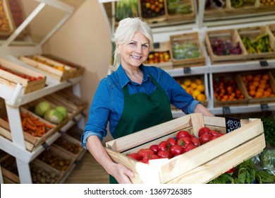 Senior Woman Working In Small Grocery Store