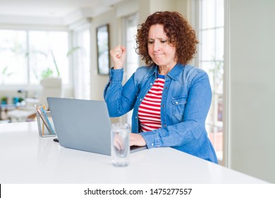 Senior Woman Working Using Computer Laptop Annoyed And Frustrated Shouting With Anger, Crazy And Yelling With Raised Hand, Anger Concept