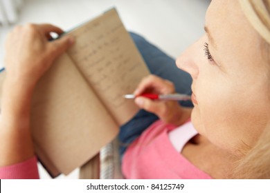 Senior Woman Writing In Notebook