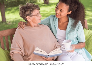 Senior Woman And Young Carer Being Friends