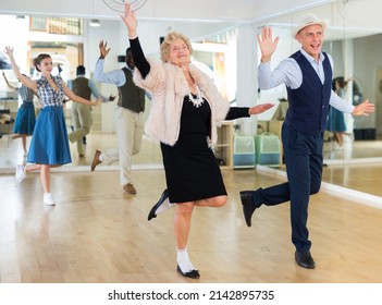 Senior Woman And Younger Man Dancing Swing