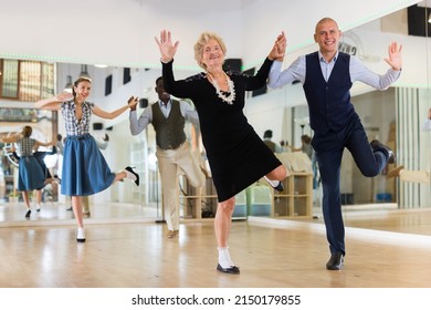 Senior Woman And Younger Man Dancing Swing