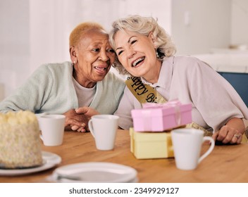 Senior women, birthday celebration and party event at a home with a present and friends gift. Surprise, happy singing and retirement of elderly people at a dining room table together with a smile - Powered by Shutterstock