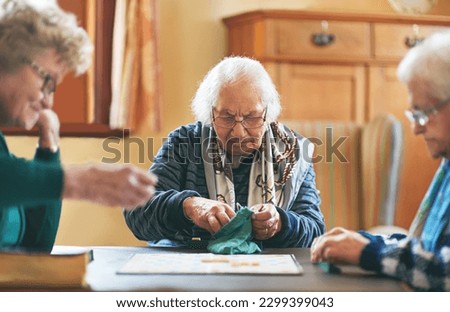 Senior women, board game and nursing home friendship or old people, thinking and play games together in retirement. Elderly group, entertainment or hobby, retired friends and assisted living activity