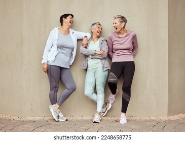 Senior women, exercise and funny with retirement, fitness and wellness, vitality and active lifestyle against wall background. Mature female friends, comedy and training, relax and sports motivation