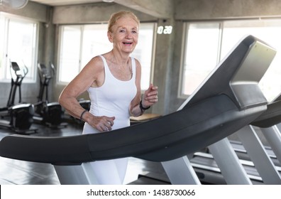 Senior Women Exercise Jogging At Gym Fitness Smiling And Happy. Elderly Healthy Lifestyle.