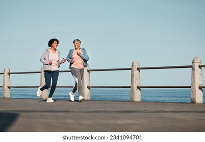 Senior women, fitness and running at beach for health, wellness and exercise in nature together. Elderly, friends and ladies at sea talking, workout and active retirement, fun and bonding ocean run - Powered by Shutterstock