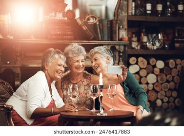 Senior women, friends and selfie in restaurant for wine, vacation and retirement together with happiness. Elderly people, reunion and memory in diner for drinks, holiday and birthday celebration - Powered by Shutterstock