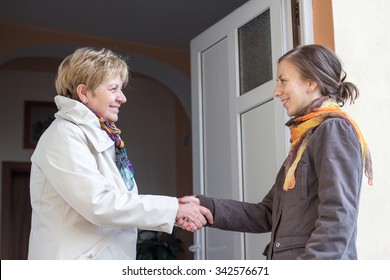 Senior women greeting young girl in the doorway - Powered by Shutterstock