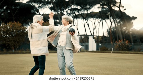 Senior women, high five and park for sport, lawn bowling and happy for fitness, goal and celebration in nature. Teamwork, elderly lady friends and metal ball for games, contest and winning together - Powered by Shutterstock