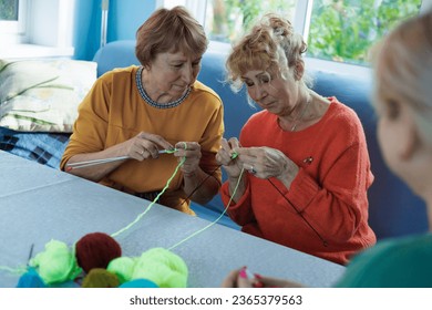 Senior women, knitting , friendship or old people, relaxing hobby in retirement. Elderly group, entertainment or hobby, retired friends and assisted living activity - Powered by Shutterstock