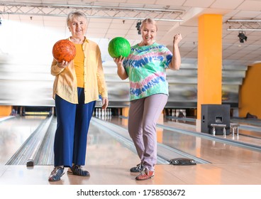 Senior Women Playing Bowling In Club