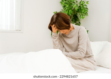 Senior women in their 50s and 60s who are waking up in their bedrooms - Powered by Shutterstock