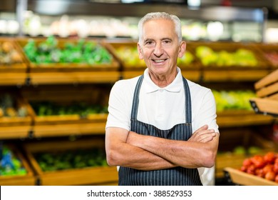 Senior worker with arms crossed in supermarket - Powered by Shutterstock