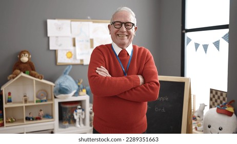 senior working as teacher smiling at kindergarten - Powered by Shutterstock