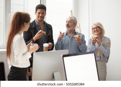 Senior And Young Diverse Colleagues Talking Eating Pizza Together In Office, Older Aged Executives Sharing Meal With Employees, Smiling Staff Team People Enjoying Lunch Time Or Coffee Break