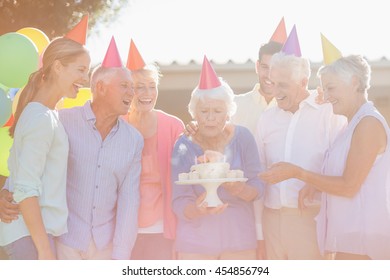 Seniors Celebrating A Birthday Outside The Retirement Home