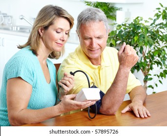 Seniors Couple At Home Measuring Blood Pressure. Home Monitoring