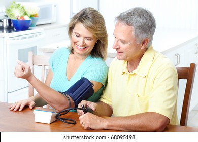 Seniors Couple At Home Measuring Blood Pressure. Home Monitoring