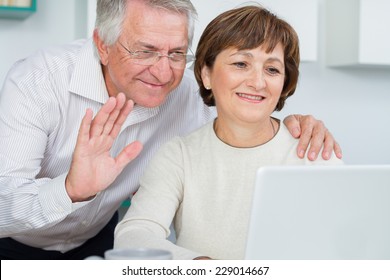 Seniors Couple Using A Computer Talking With Video Chat 