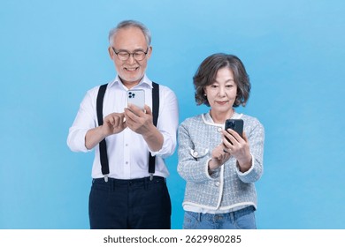 Seniors enjoying technology while using smartphones against a blue background